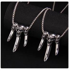 Macro detail of gothic skull and claw pendant in polished stainless steel punk style
