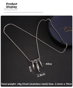 Detail view of gothic triple skull pendant with sharp fangs on a stainless steel chain
