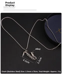 Detail view of saxophone pendant necklace showing 4.5cm by 3.3cm dimensions on leather