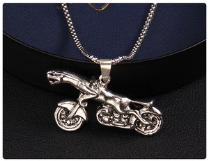 Macro detail of vintage silver leopard motorcycle pendant on a box chain for men