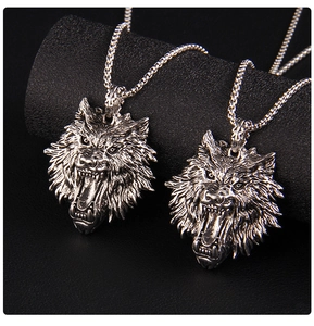 Detailed view of silver stainless steel roaring wolf head pendants on box chains
