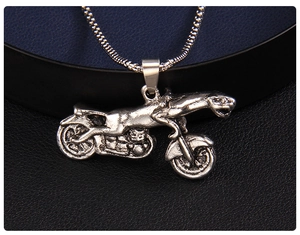 Detailed view of retro silver leopard motorcycle pendant with vintage punk style texture