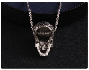 Macro shot of silver hollow skull pendant featuring detailed gothic texture and box chain