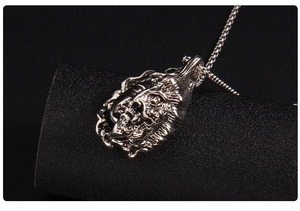 Macro detail of gothic style silver lion pendant necklace with intricate metal carving
