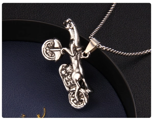 Close-up of vintage punk leopard riding motorcycle pendant with heavy metal finish