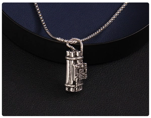 Detailed view of punk-style TNT explosive pendant on a vintage silver box chain
