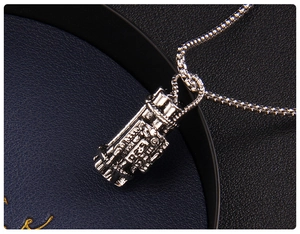 Close-up of a silver Gatling gun pendant with a detailed box chain for men's fashion