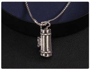 Macro shot of silver Gatling cylinder pendant with vertical stripes on a bead chain