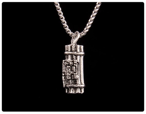 Detailed close-up of a silver gatling dynamite pendant with a classic box chain