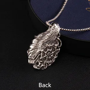 Vintage gothic heavy metal pendant back view with intricate flame and wheel engraving
