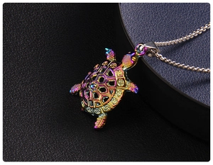 Macro shot of colorful iridescent sea turtle pendant with intricate hollow-out shell details