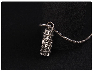 Macro view of vintage silver Gatling pendant with 520 engraving on black leather