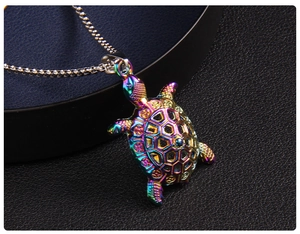 Macro detail of rainbow gradient sea turtle pendant with hollow hexagonal shell patterns