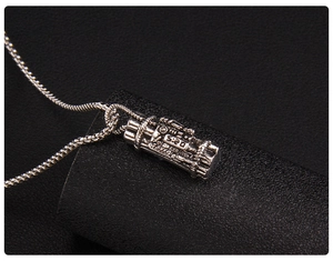 Macro shot of industrial robot pendant with 520 engraving and box chain details