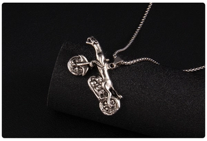 Macro shot of a vintage leopard on a motorcycle pendant with silver box chain necklace