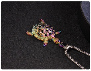 Macro shot of a colorful iridescent sea turtle pendant with hollow geometric patterns