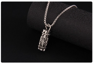 Detail shot of vintage punk necklace showing the cylinder pendant with 520 engraving