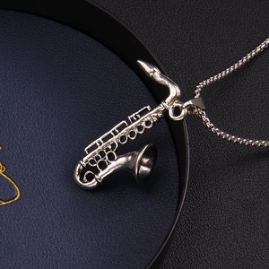 Polished silver stainless steel saxophone pendant necklace with detailed musical instrument keys