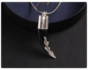Macro shot of back detail on black wolf tooth pendant with silver flame pattern