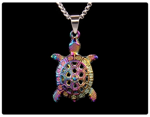 Macro detail of iridescent sea turtle pendant with hollow shell on a silver box chain