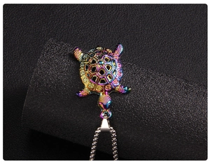 Macro view of a colorful rainbow sea turtle pendant with geometric hollow-out patterns
