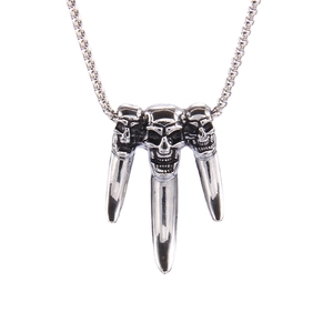 Gothic punk necklace featuring three silver stainless steel skulls and claw pendants