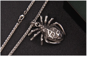 Macro detail of gothic stainless steel spider pendant with intricate textured engraving
