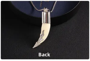 Macro close-up showing the detailed back side of a vintage tribal wolf tooth pendant