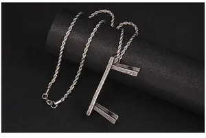 Close-up of twist chain and wood grain texture rectangle pendant in stainless steel