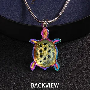 Rainbow iridescent sea turtle necklace back view with stainless steel chain on black