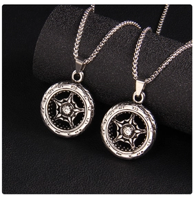 Détail d'un pendentif roue dentée argentée vintage avec chiffres romains sur fond noir