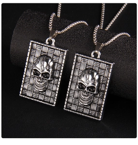 Macro detail of gothic skull pendant with woven texture on vintage silver necklace