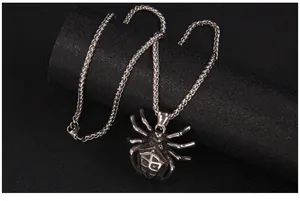 Macro detail of retro silver spider pendant with dragon scale chain in punk style