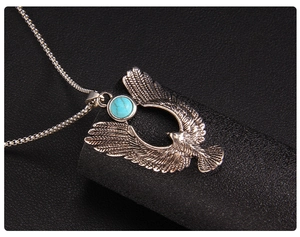 Detailaufnahme des Vintage Adler-Anhängers mit grünem Türkisstein auf Ledergrund