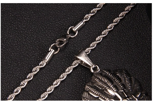 Macro shot of silver stainless steel twisted rope chain with detailed radial engraving