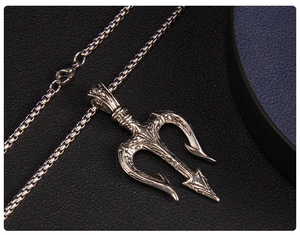 Macro detail of Poseidon trident pendant with vintage engraving and box chain clasp
