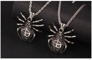 Detailed view of punk spider pendants with twist and pearl chains in vintage steel