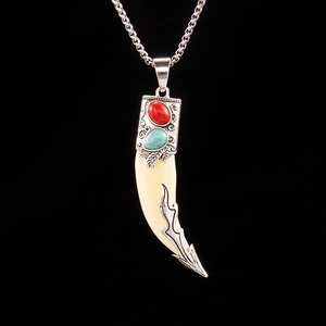 Vintage tribal wolf tooth necklace with silver metallic filigree and red green gems
