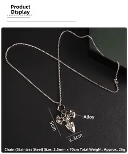 Detailed close-up of punk style cross and skull pendant with crystals on stainless steel chain