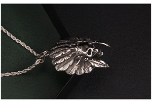Detail of silver stainless steel Indian skull pendant with intricate feather headdress