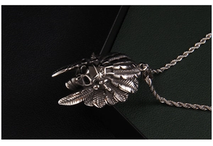 Detail of vintage stainless steel skull pendant with indian feather headdress on twist chain