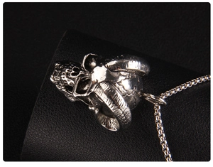 Macro detail of gothic ram skull pendant in vintage stainless steel with weathered finish