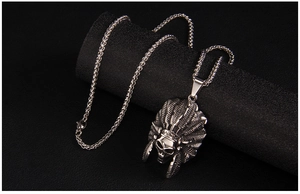 Detailed close-up of a vintage steel Indian chief skull pendant on a wheat chain