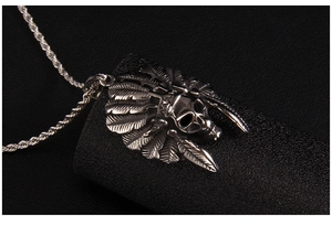 Macro view of retro punk skull pendant with Indian feather headdress and silver texture