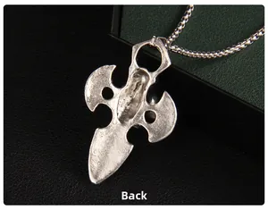 Macro detail of the back of a silver gothic sword pendant with a sleek metallic chain