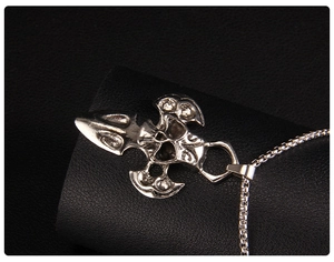 Macro shot of gothic punk skull and cross pendant with vintage silver finish details