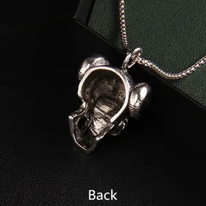 Back side view of vintage silver bull skull pendant with long chain on leather