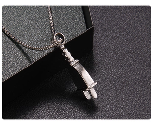 Macro shot of punk style metal power plug pendant on a black textured background