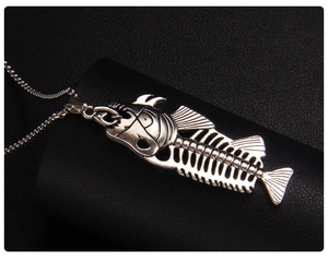 Detailed view of vintage silver fishbone pendant with intricate hollowed ribs on black leather
