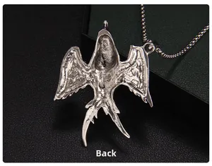 Detail view of the textured back of a flying bird pendant with a silver metal finish